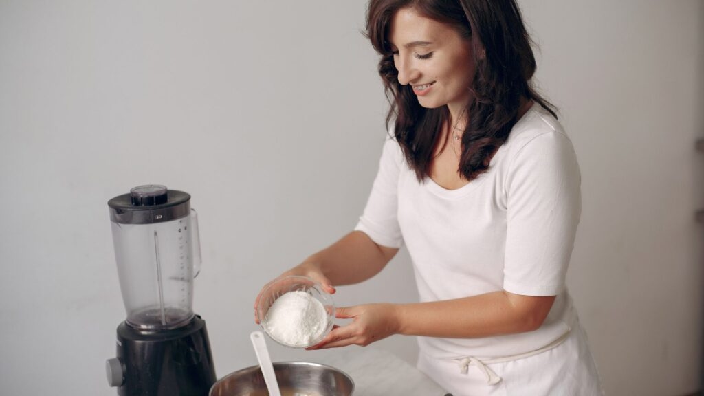 Female Baker Adding Flour to Chocolate Cake Batter