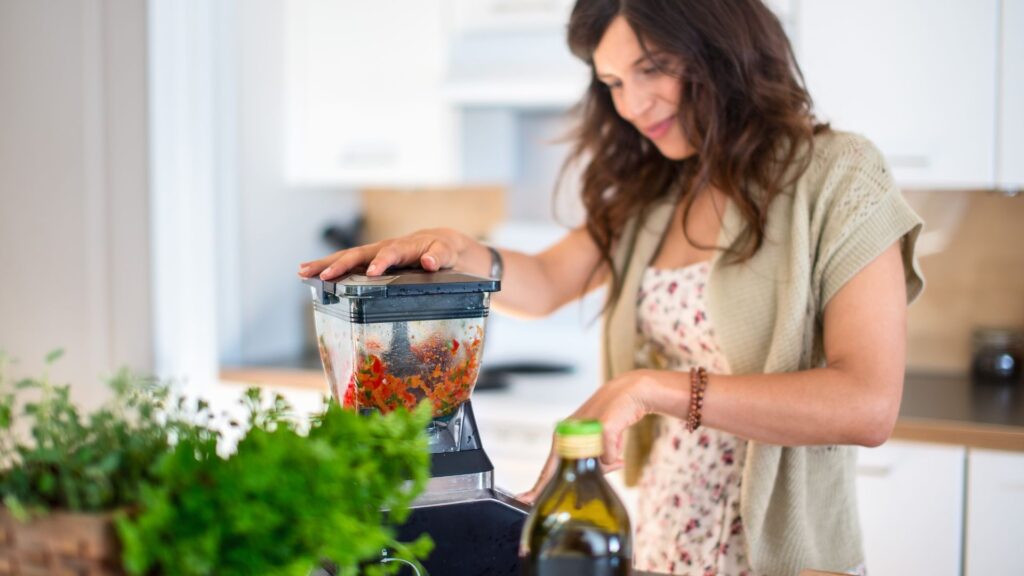 Health conscious woman using a blender