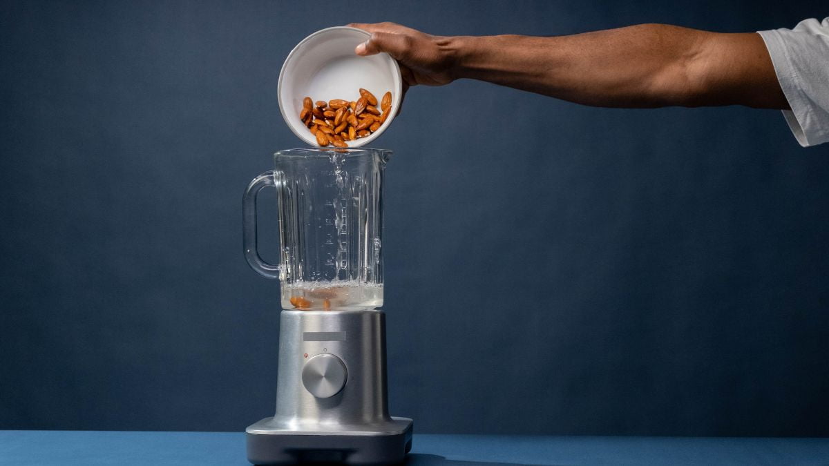 Pouring of Pecan Nuts on a Blender