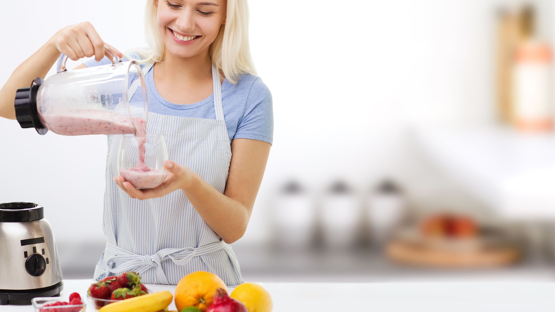 Smiling-Woman-with-Blender-and-Fruit-Milk-Shake
