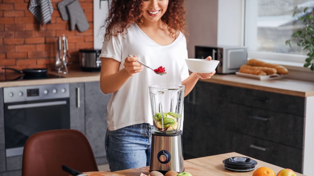 Woman Making Smoothie in Kitchen at Home