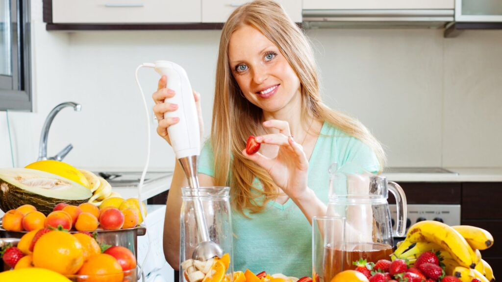 girl making beverages with electric blender